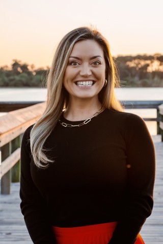 Lauren Leslie Lortie, REALTOR® — portrait on a Southwest Florida dock at golden hour